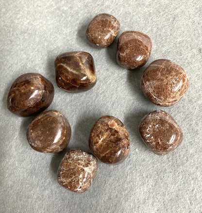 Front view of Hessonite Garnet Crystals on a gray surface