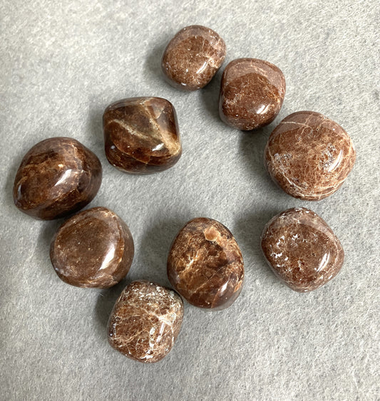 Front view of Hessonite Garnet Crystals on a gray surface