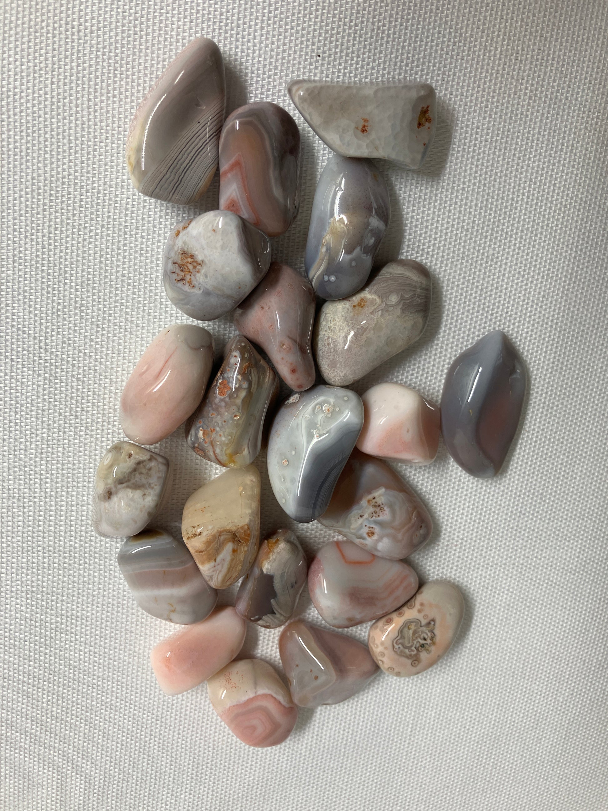 Back view of Botswana Agate Crystals on a textured gray surface