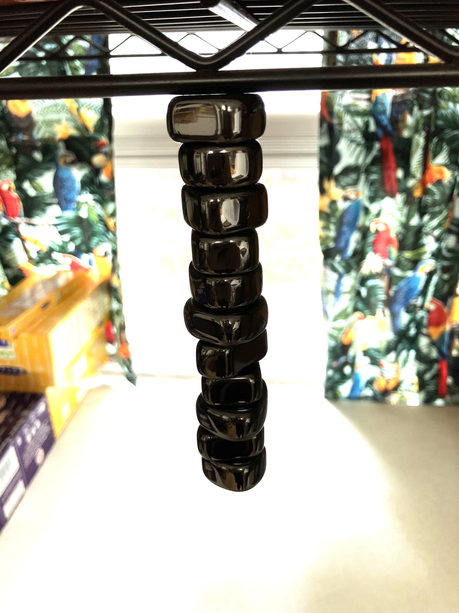Magnetic Hematite Crystals hanging from a metal rack in a store setting