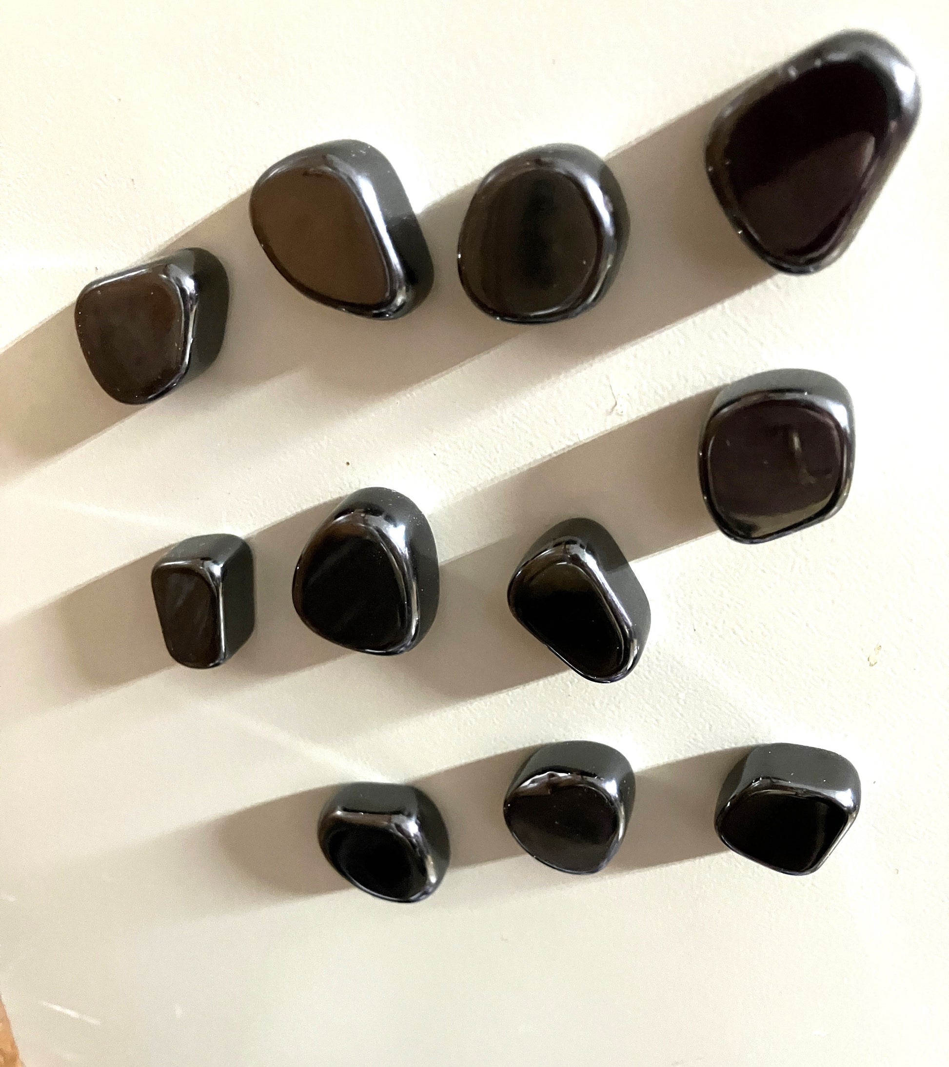 Magnetic Hematite Crystals arranged in a grid on a white background