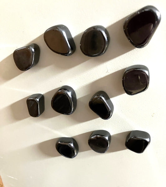 Magnetic Hematite Crystals arranged in a grid on a white background