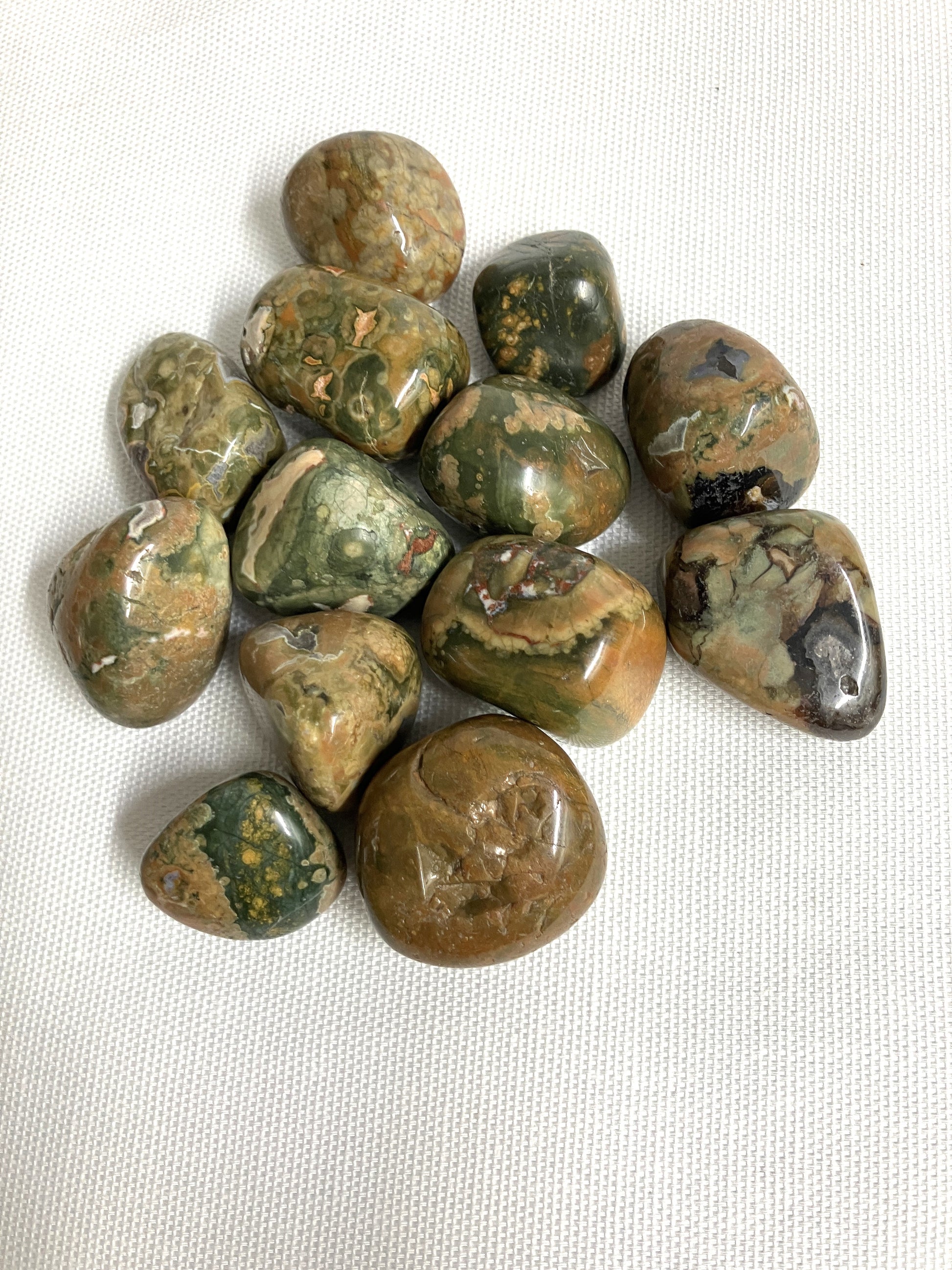 Front side of Rhyolite Crystals on a white fabric background