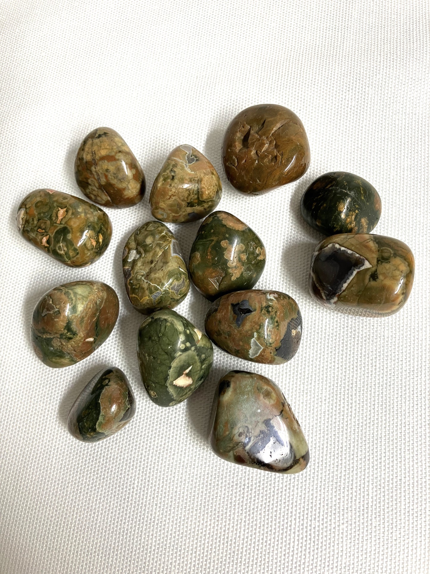 Collection of Rhyolite Crystals on a white fabric background