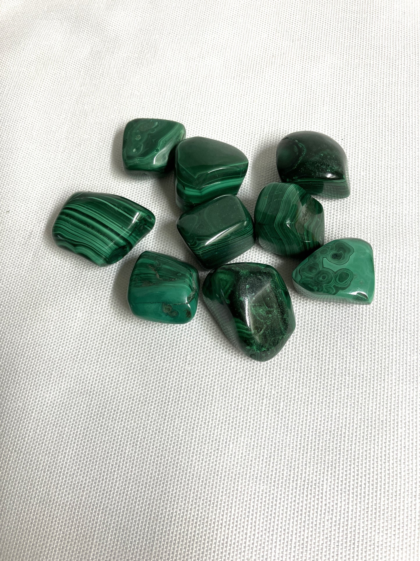 Malachite Crystals on a white fabric background