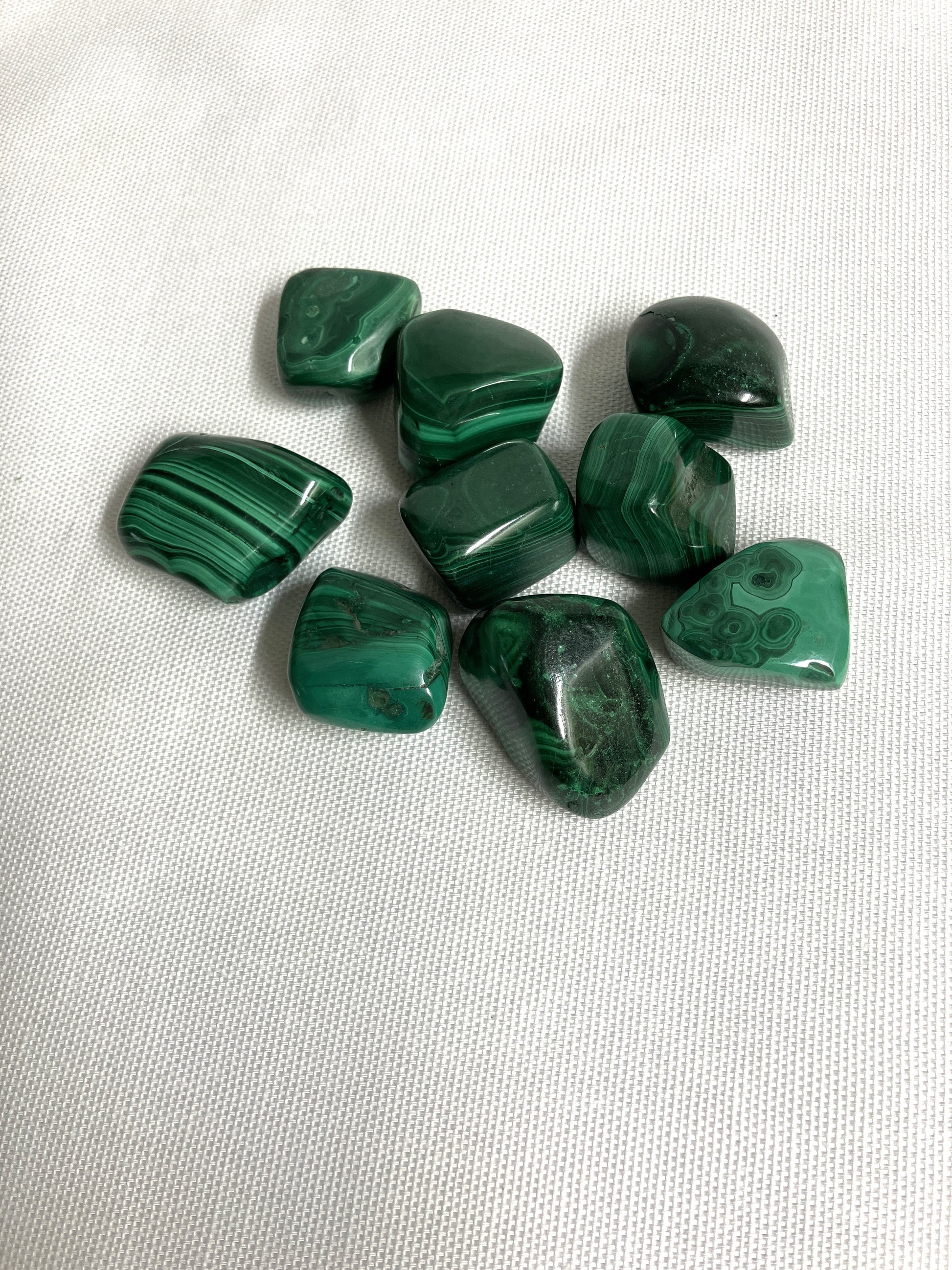 Malachite Crystals on a white fabric background