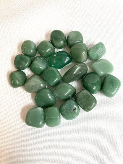 Green Aventurine Tumbled Crystals  front view on a white fabric background