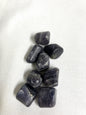 Group of Tumbled Iolite Crystals on a white fabric background