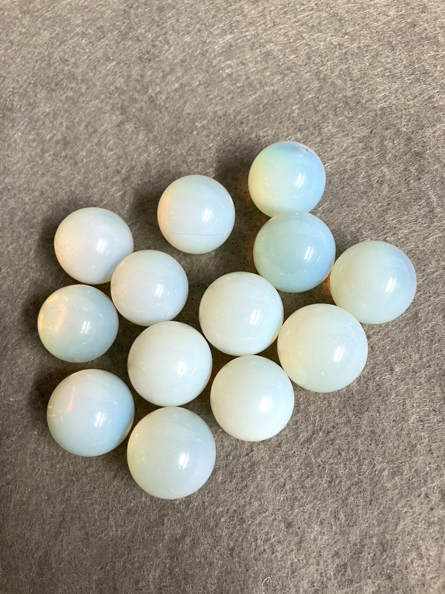 Opalite Spheres showing a different side on a gray surface