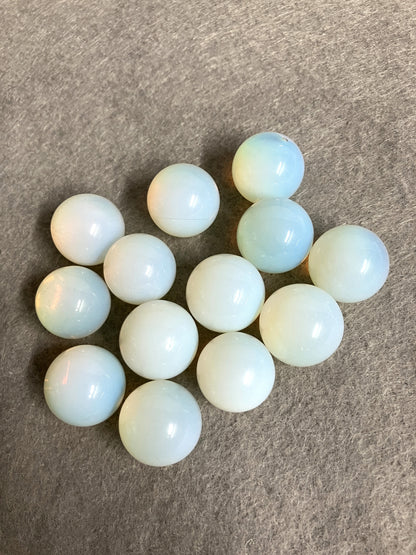 Opalite Spheres showing a different side on a gray surface