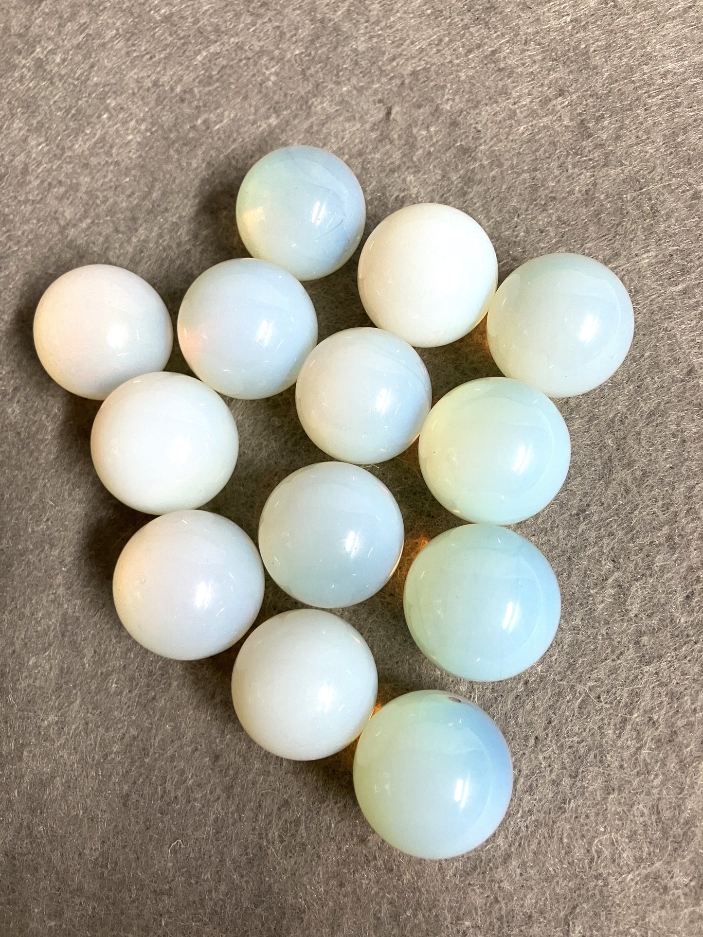 Opalite Spheres showing the color arranged in a circular pattern on a brown surface