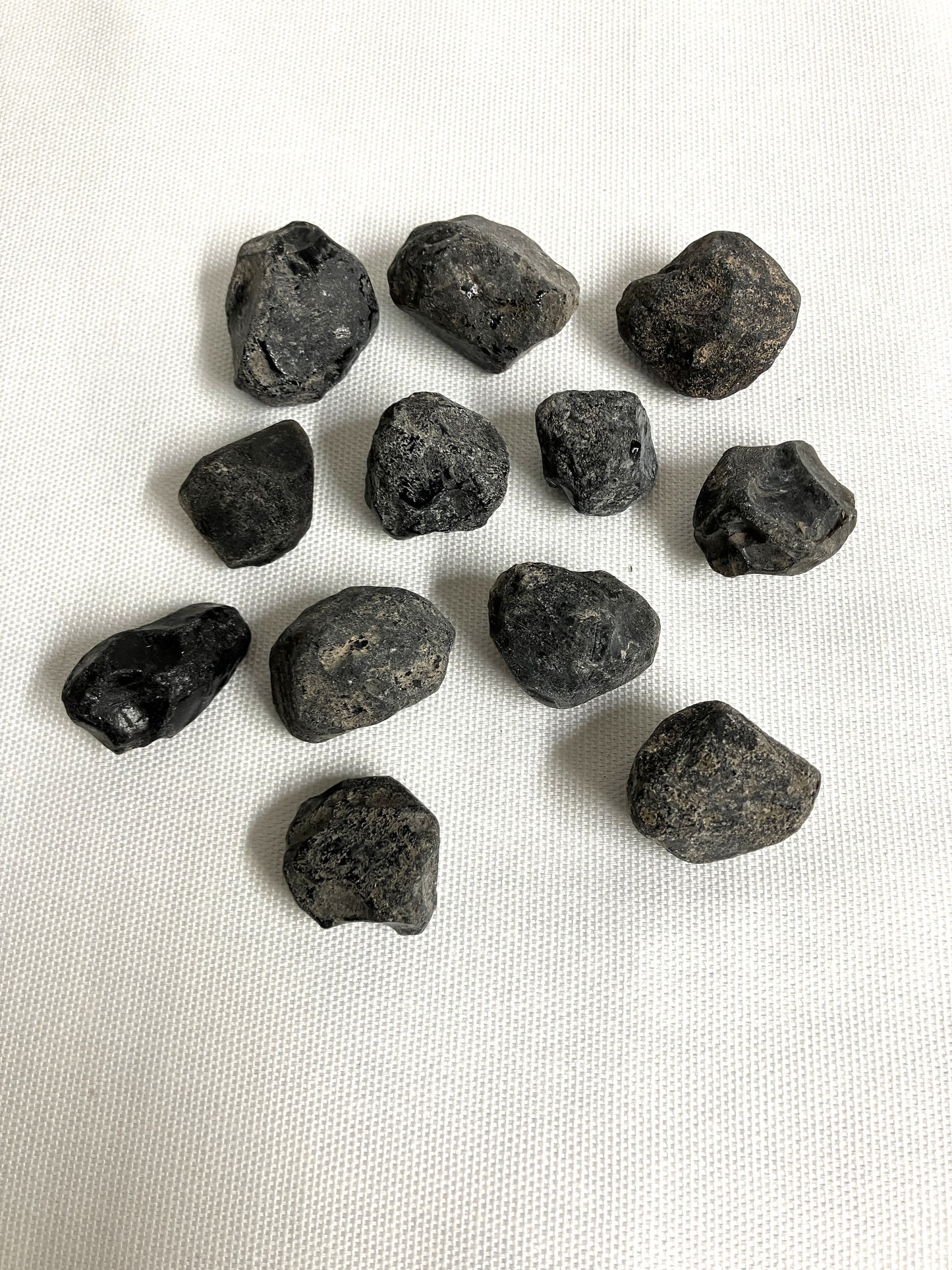 Front view of Rough Apache Tears on a white fabric background