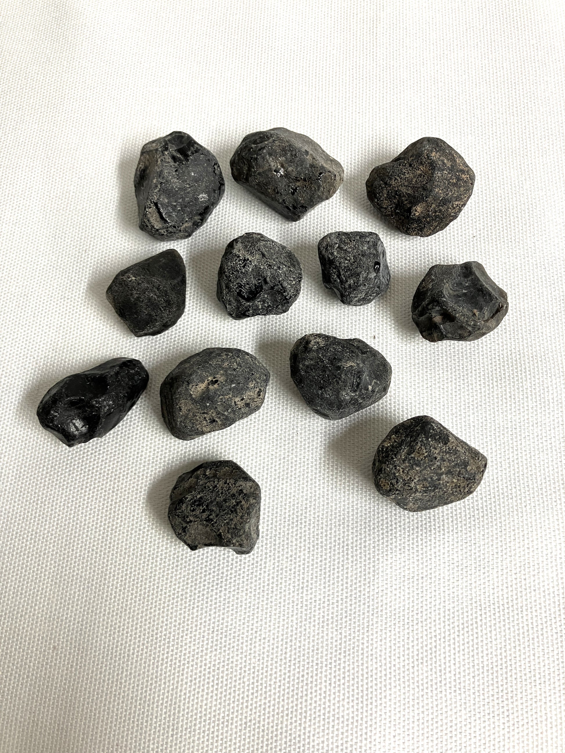 Front view of Rough Apache Tears on a white fabric background