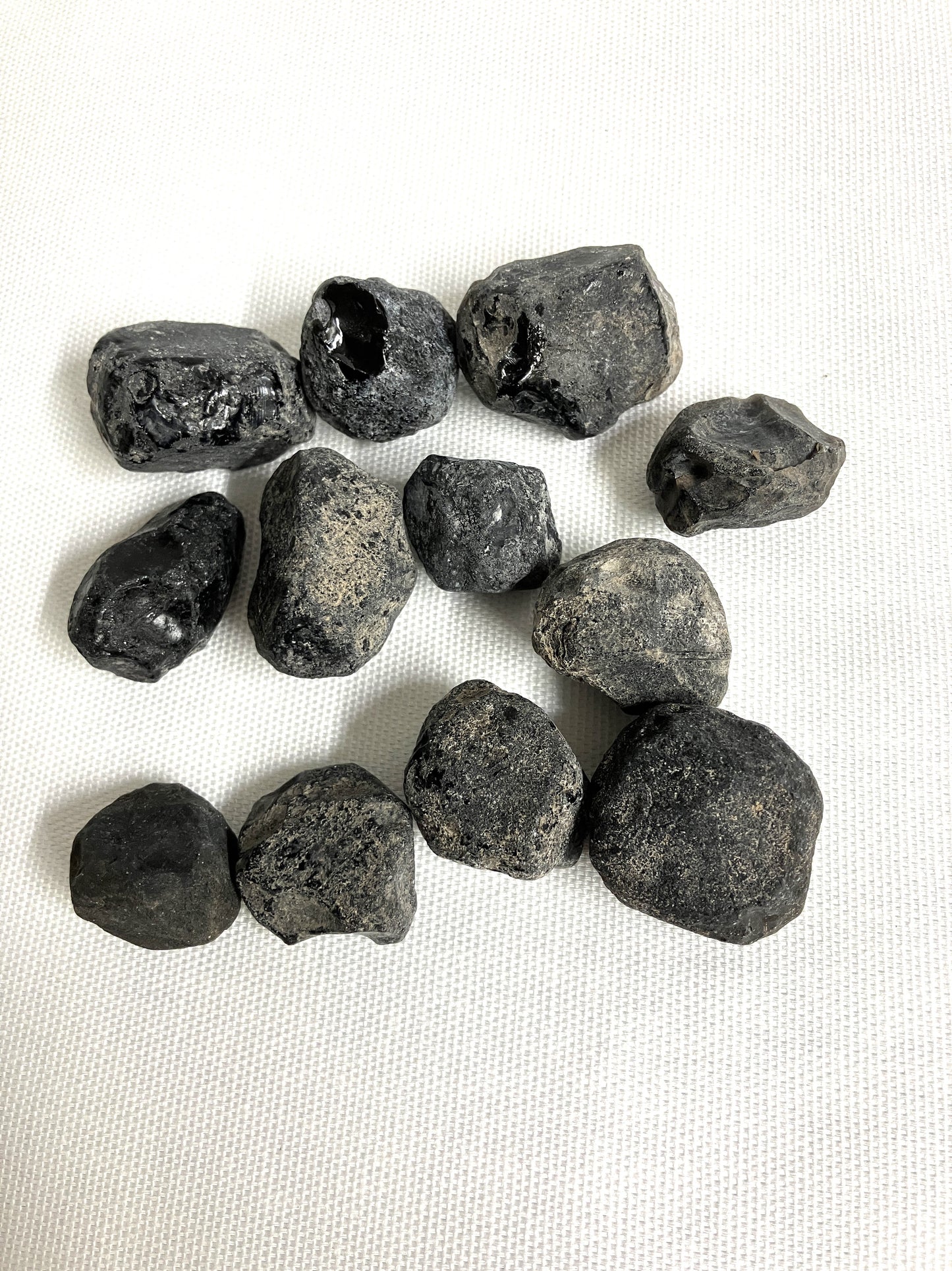 Front view of Rough Apache Tears on a white fabric background