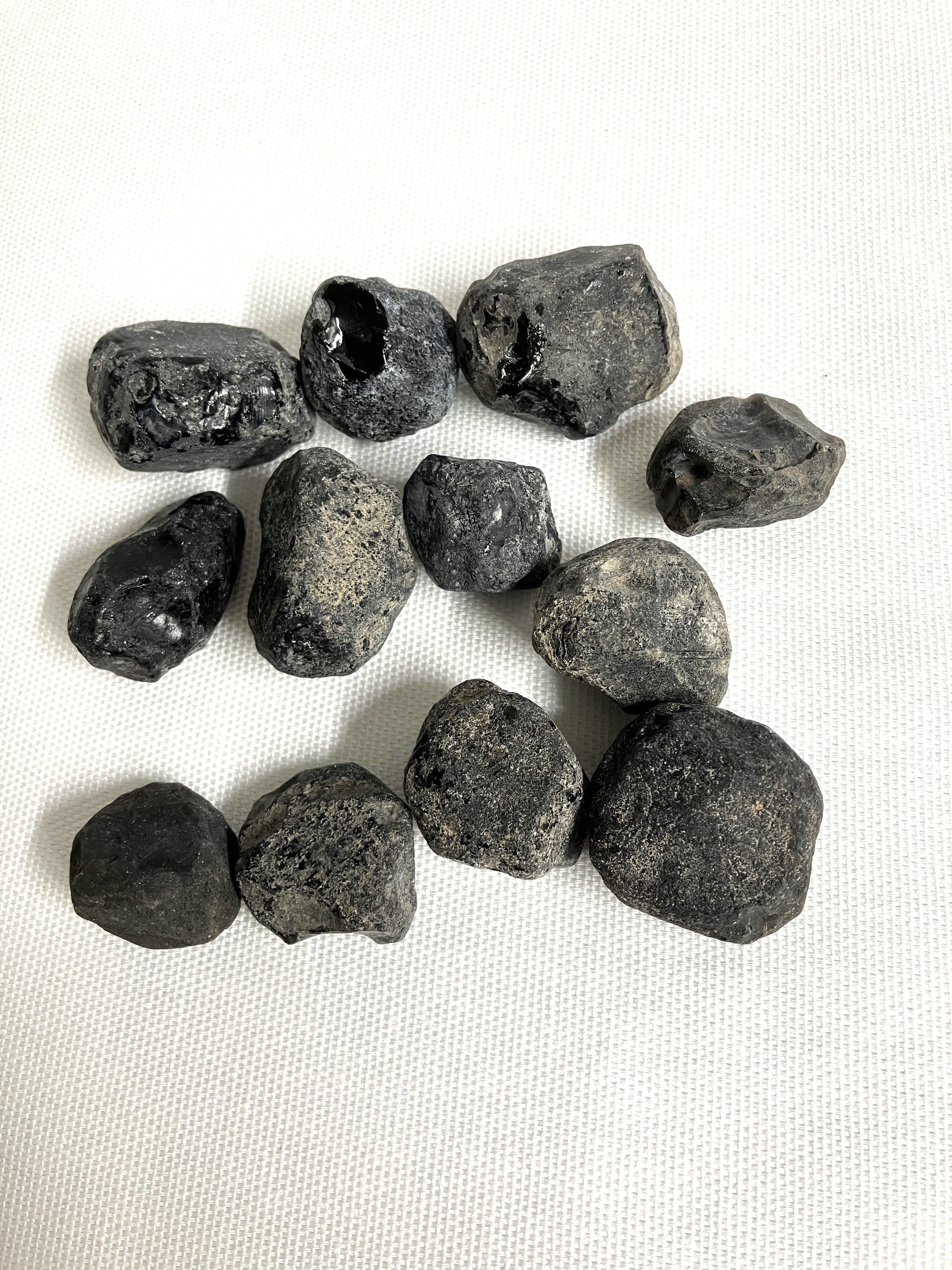 Front view of Rough Apache Tears on a white fabric background