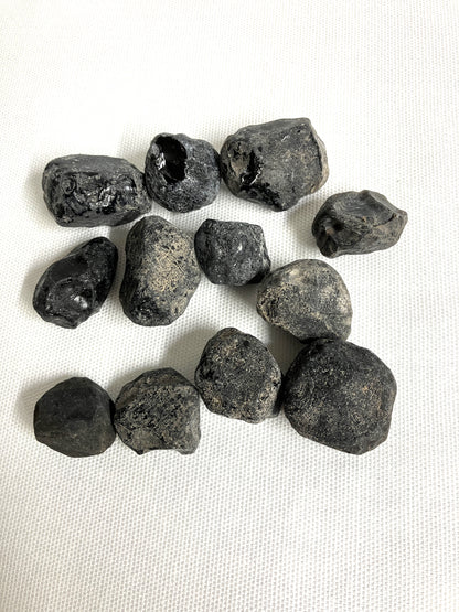 Front view of Rough Apache Tears on a white fabric background