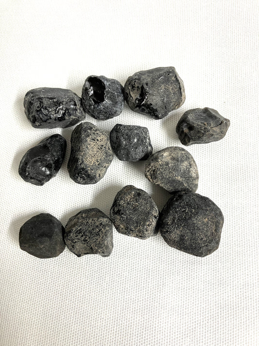 Front view of Rough Apache Tears on a white fabric background