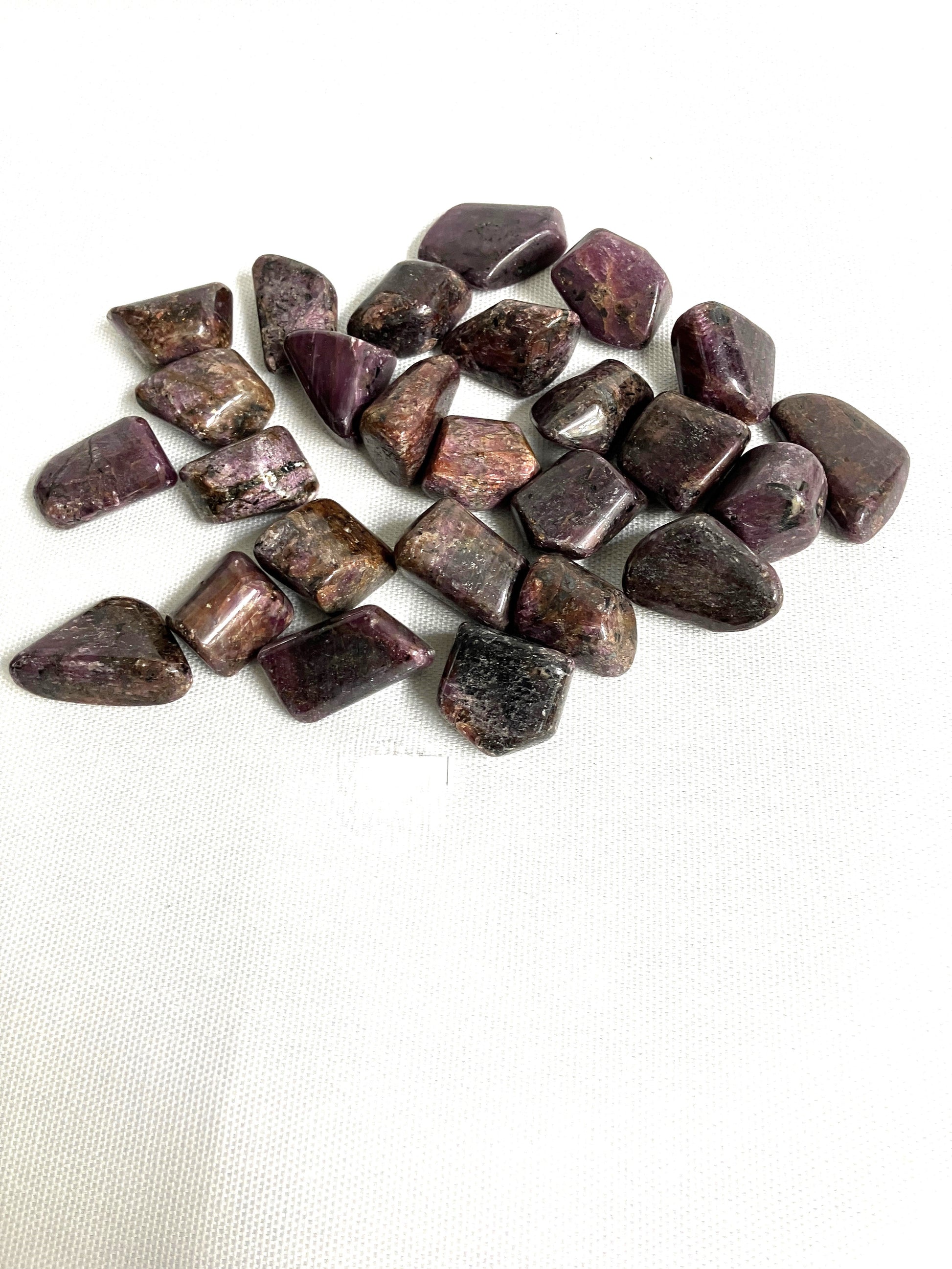Showing the Back side of Ruby Crystals on a white fabric background