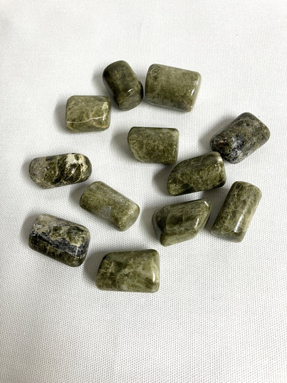 Back view of Vesuvianite Tumbled Crystals on a white fabric background