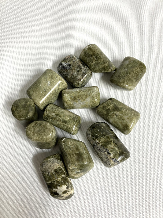 Front view of Vesuvianite Tumbled Crystals on a white fabric background