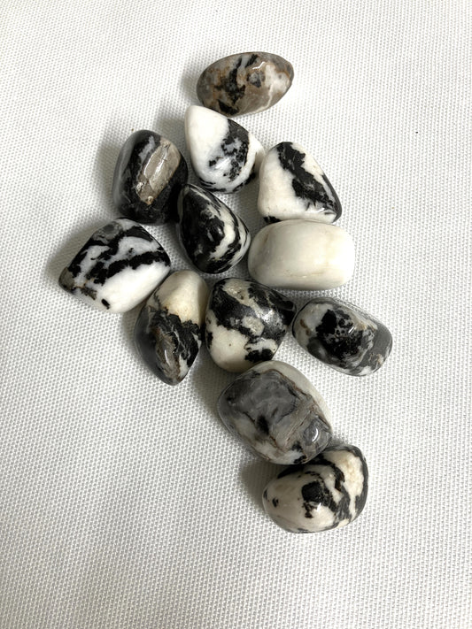 Front view of Black Zebra Jasper Crystals on a light fabric background