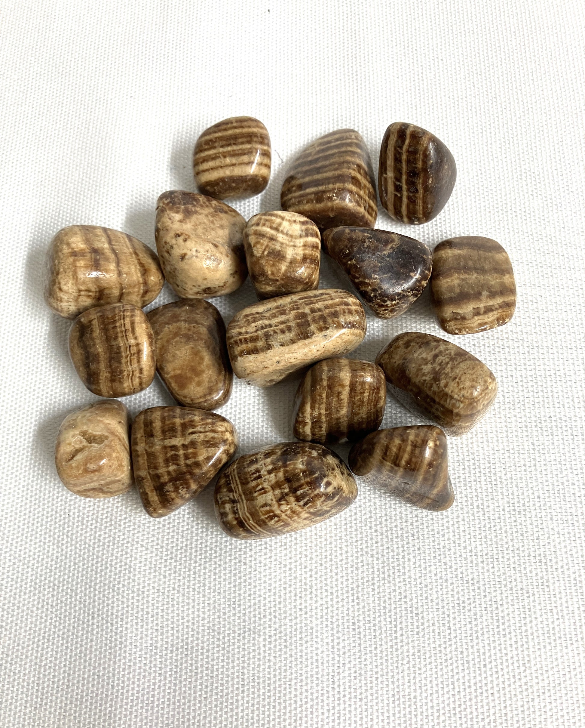 Tumbled Aragonite Crystals on a white fabric background