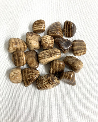Tumbled Aragonite Crystals on a white fabric background