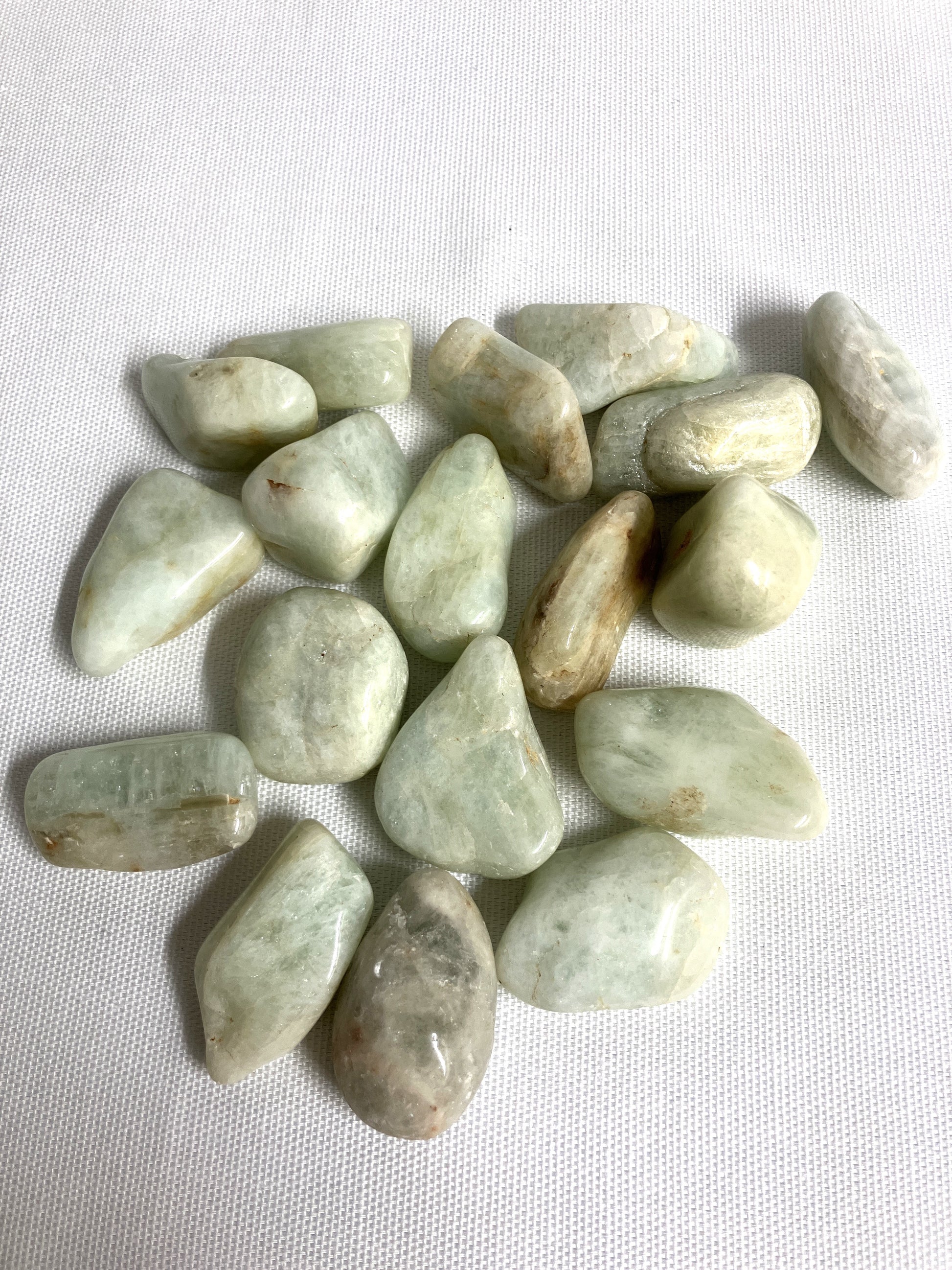 Front view of Aquamarine Crystals on a white fabric background