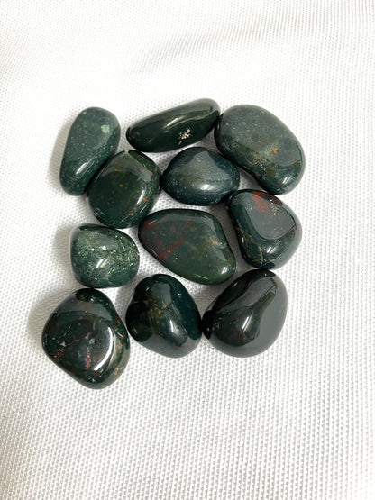 Tumbled Bloodstone Crystals on a white fabric background