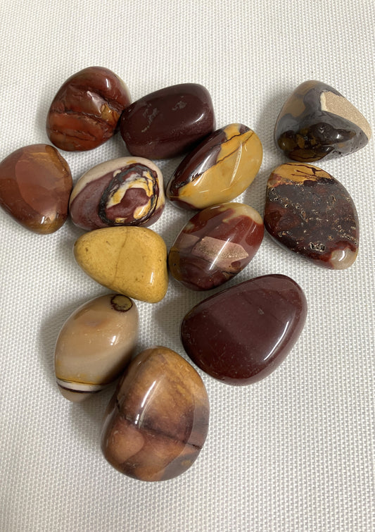 Collection of Mookaite Crystals on a textured fabric background