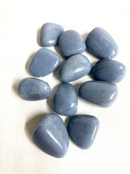 Front side of Angelite Crystals on a textured white surface