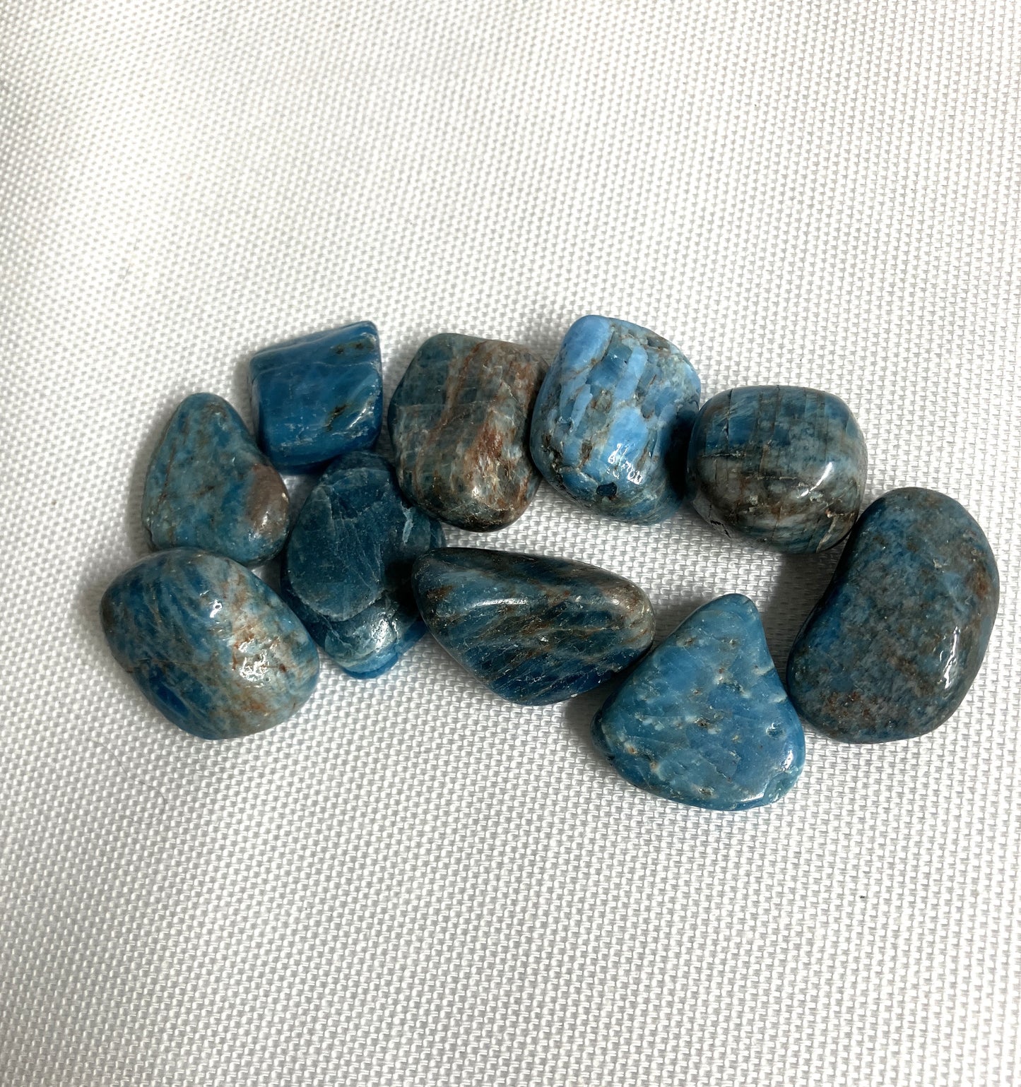 Back view of Blue Apatite Crystals on a textured white surface