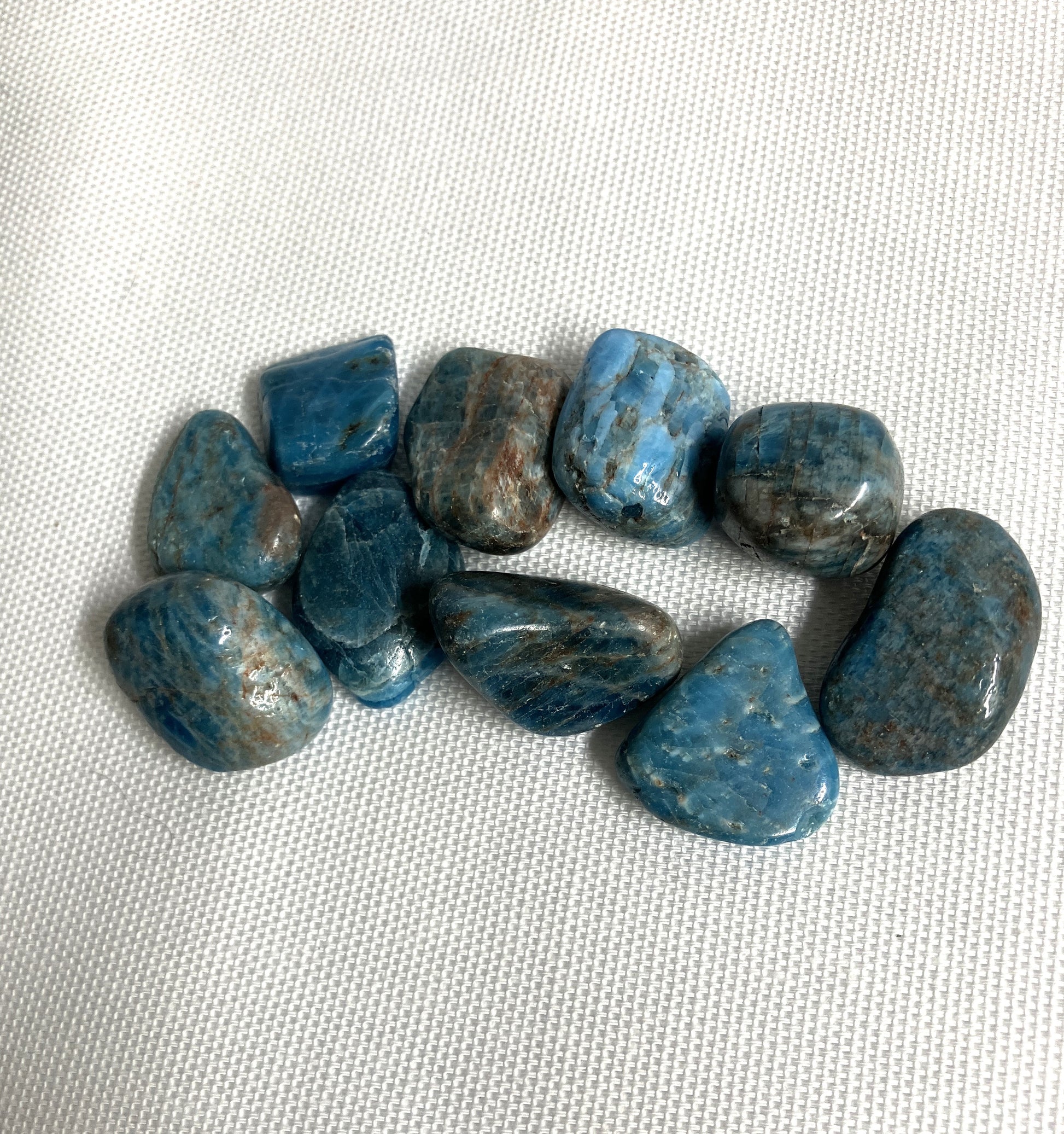 Back view of Blue Apatite Crystals on a textured white surface