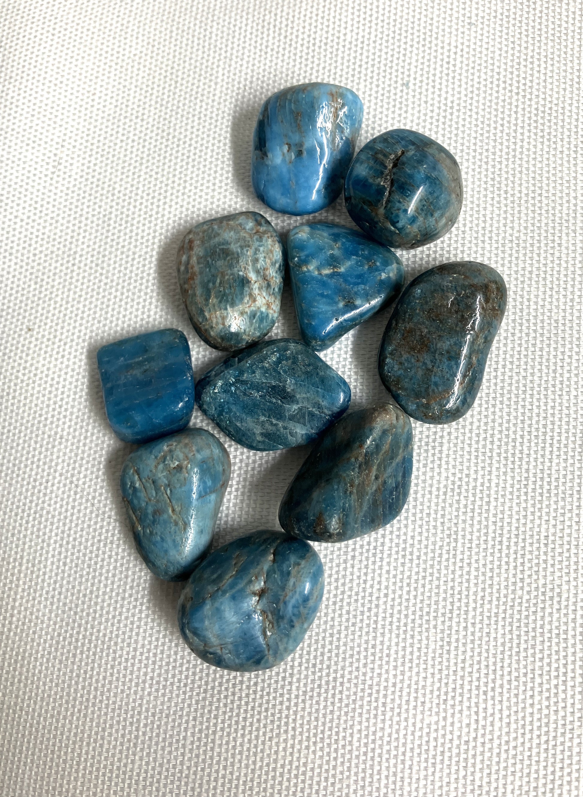 Front view of Blue Apatite Crystals on a textured white surface