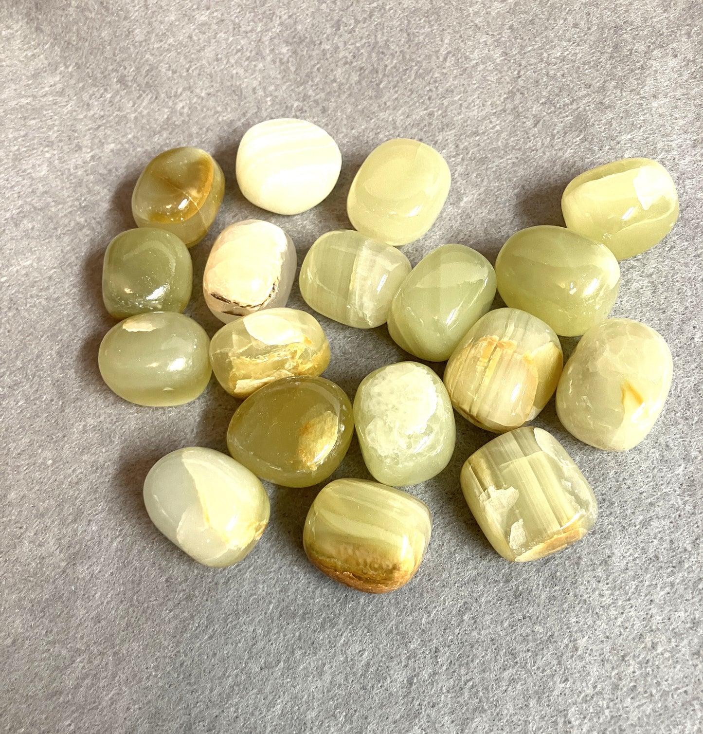 Closeup of the front of Green Calcite Crystals on a gray surface