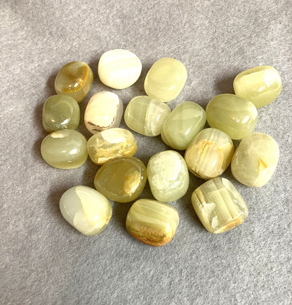 Closeup of the front of Green Calcite Crystals on a gray surface