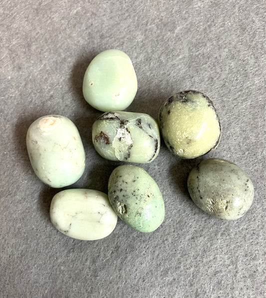 Green Chrysoprase Crystals on a gray surface