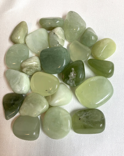 Group of New Jade Crystals on a white fabric background view 3