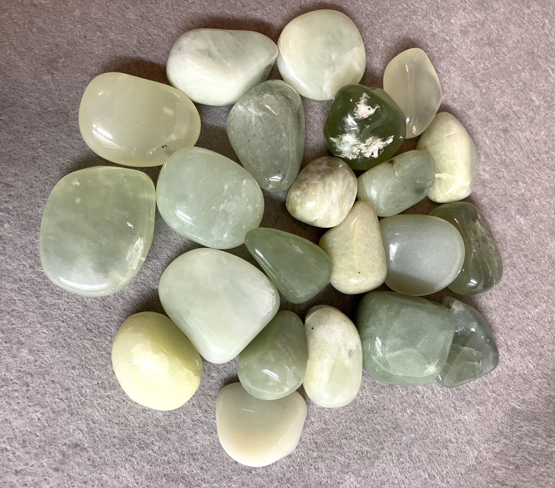 Grouping of New Jade Crystals  on a gray surface view 2