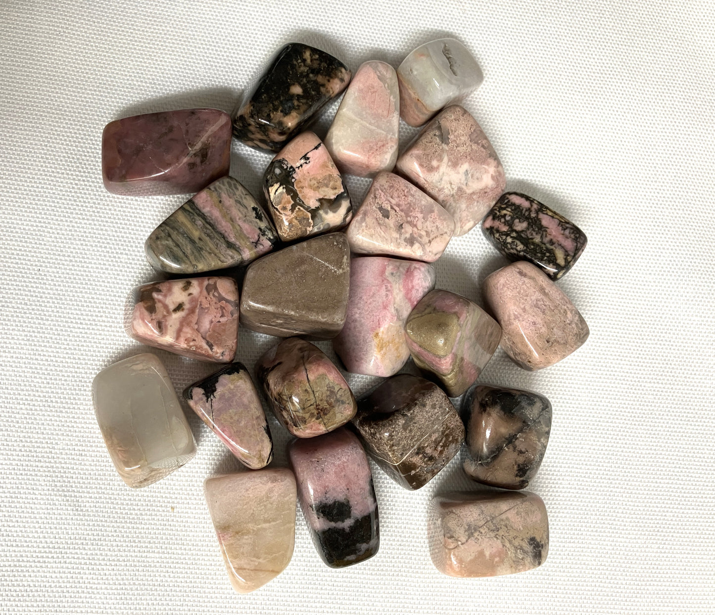 Top view of Rhodonite Crystals on a textured white surface