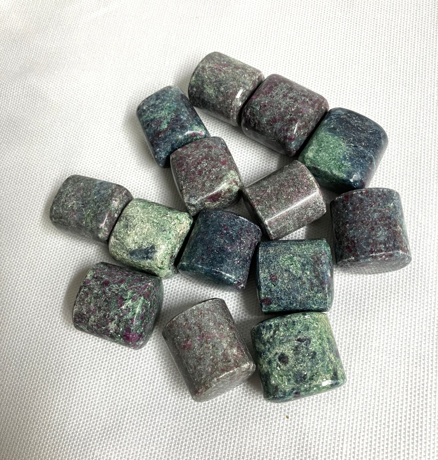Collection of Ruby Kyanite Crystals on a white fabric background