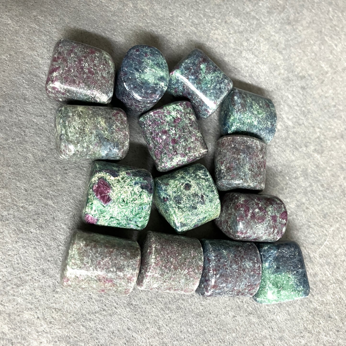 Back view of Ruby Kyanite Crystals on a gray surface