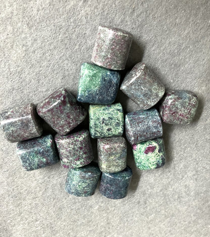 front view of Ruby Kyanite Crystals  on a gray surface