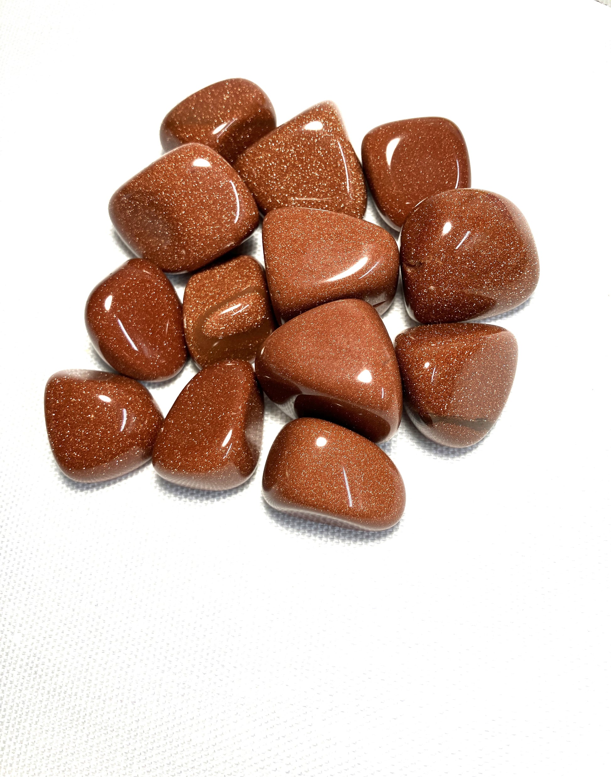 Red Goldstone Crystals showing the sparkles within on a white background