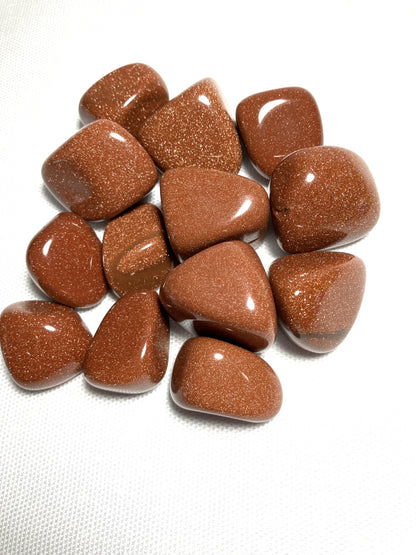 Group of Red Goldstone Crystals  showing different patterns on a white background