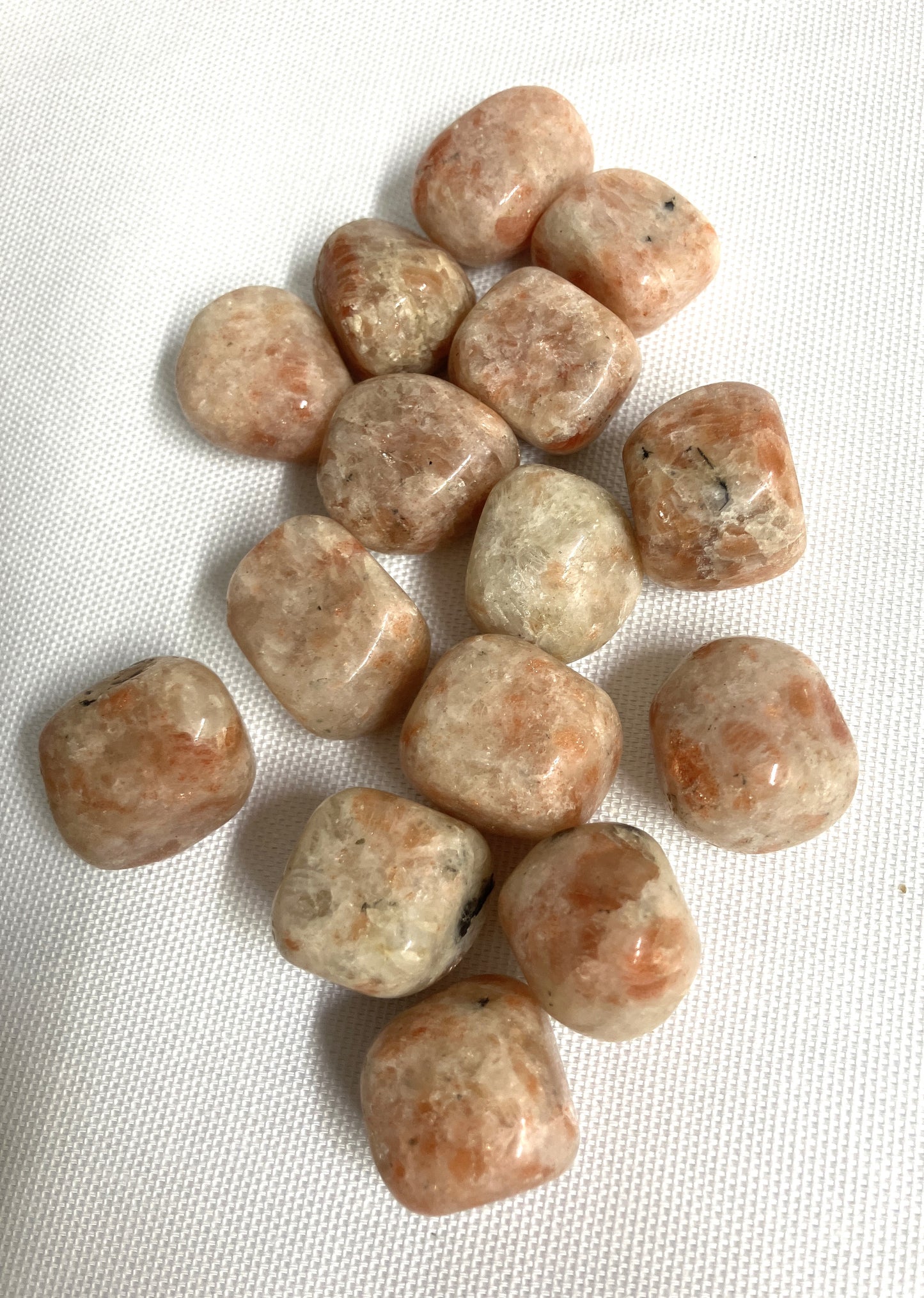 Bottom view of Sun Stone Crystals on a white fabric background