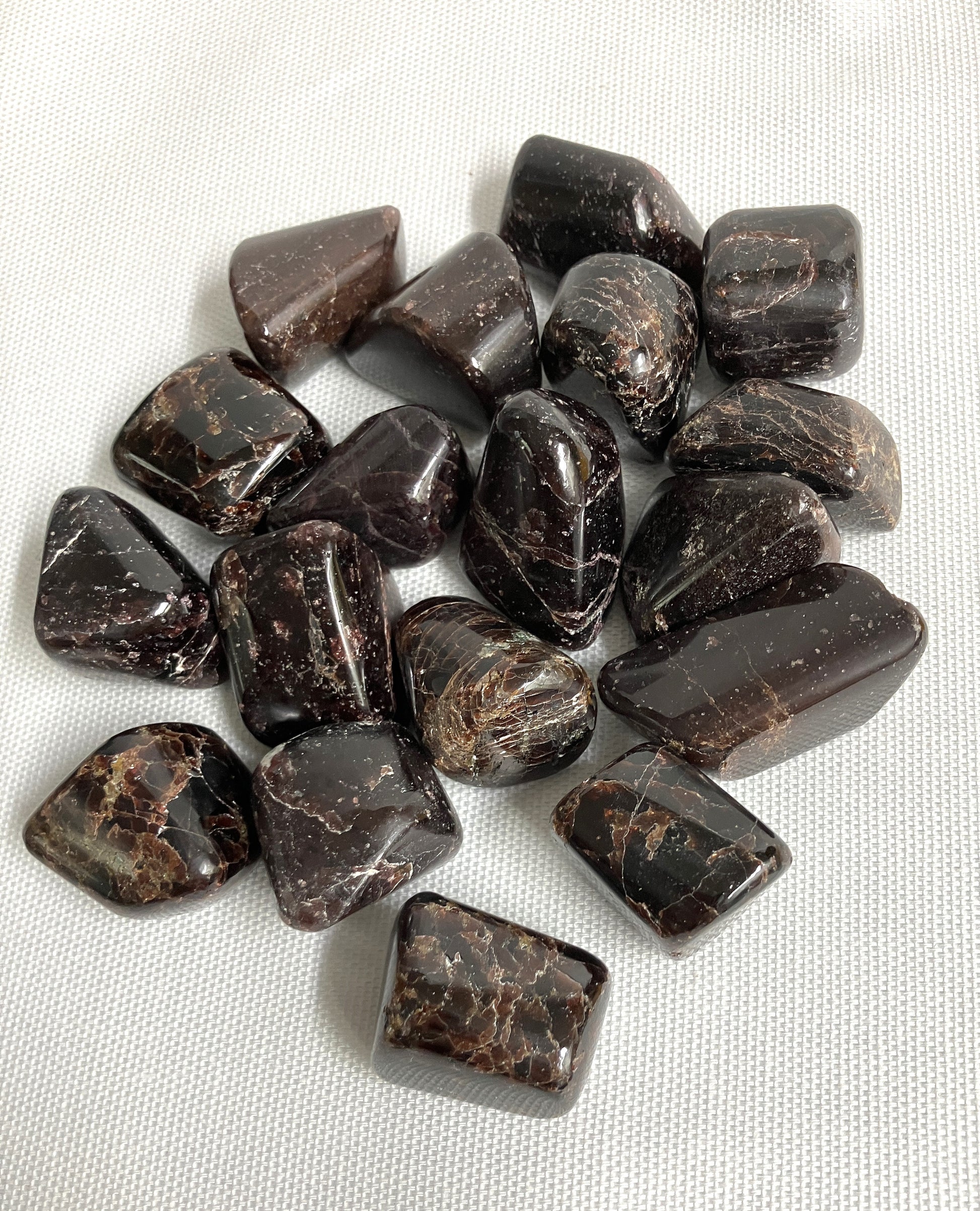 Bottom view of Almandine Garnet Crystals on a white fabric background