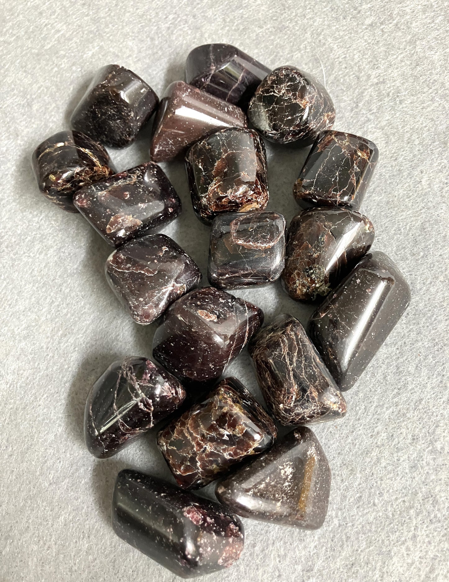 Front side view of Almandine Garnet Crystals on a light gray background