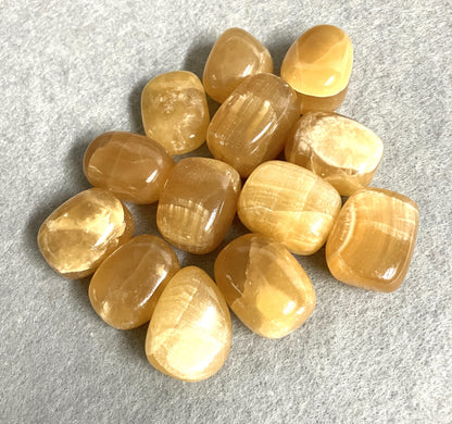 Bottom view of Honey Caramel Calcite Crystals on a gray surface
