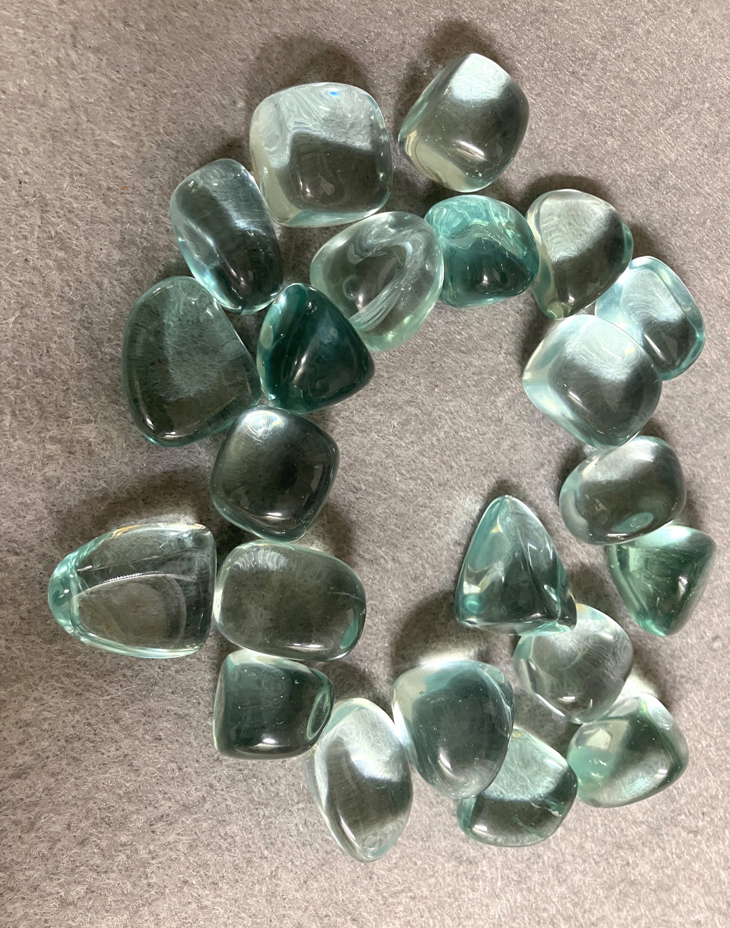 Collection of Blue Obsidian Crystal on a beige surface